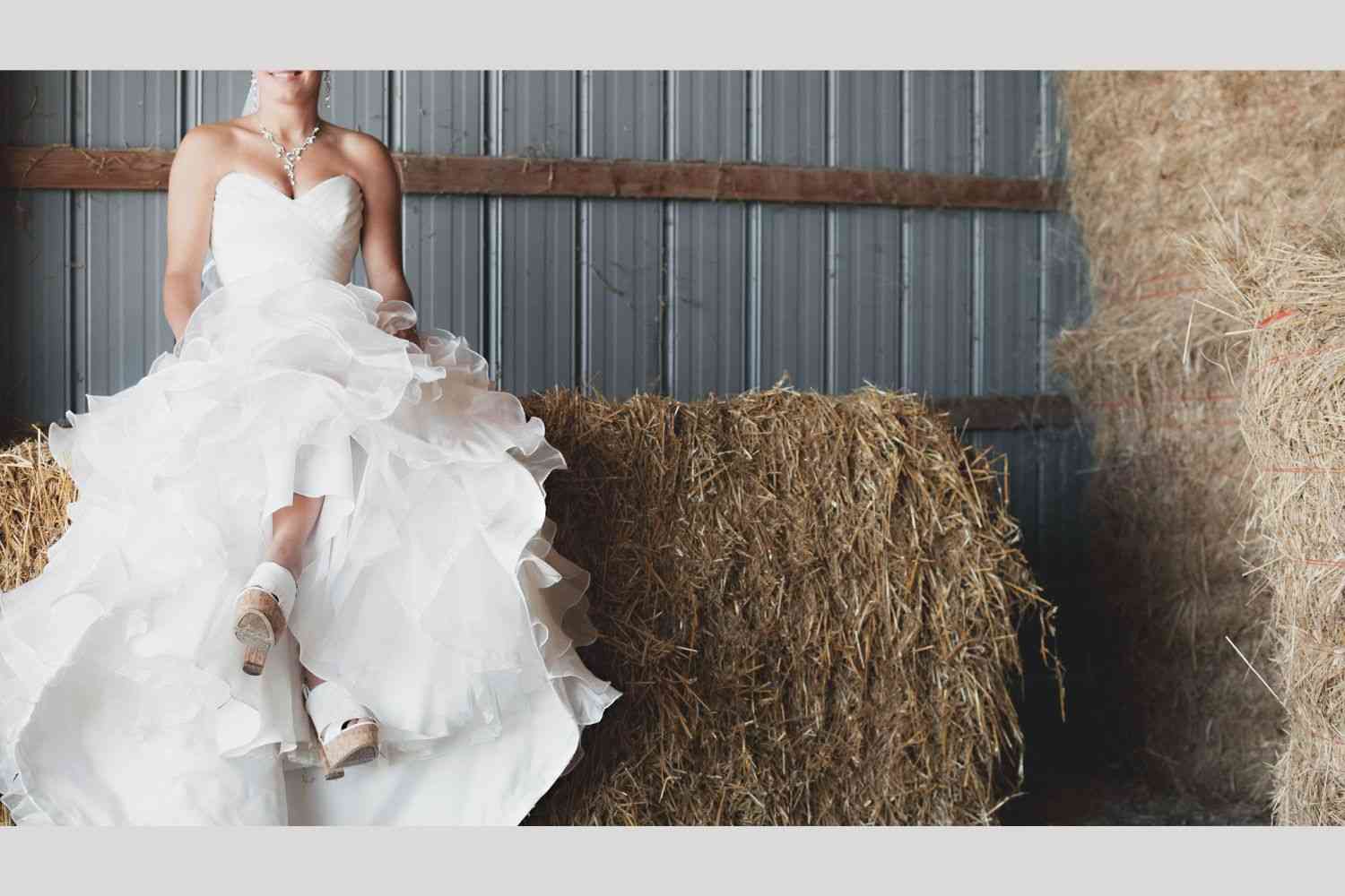 woman sits on hay bale