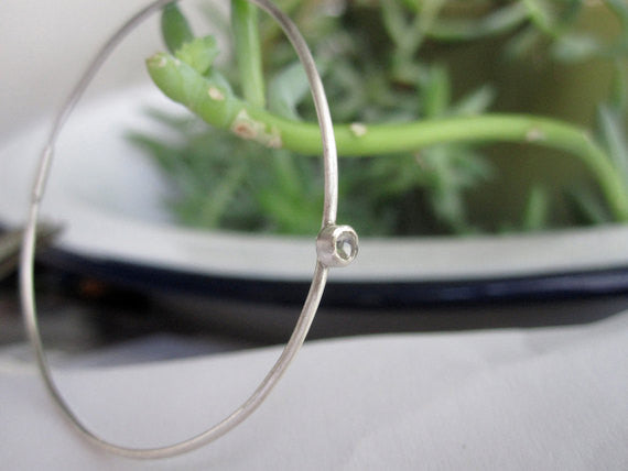 Elegant And Attractively Designed Sterling Silver Round Wire Hoops With A White Topaz Insert - 0189