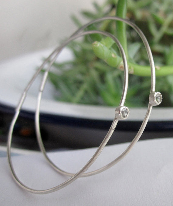 Elegant And Attractively Designed Sterling Silver Round Wire Hoops With A White Topaz Insert - 0189