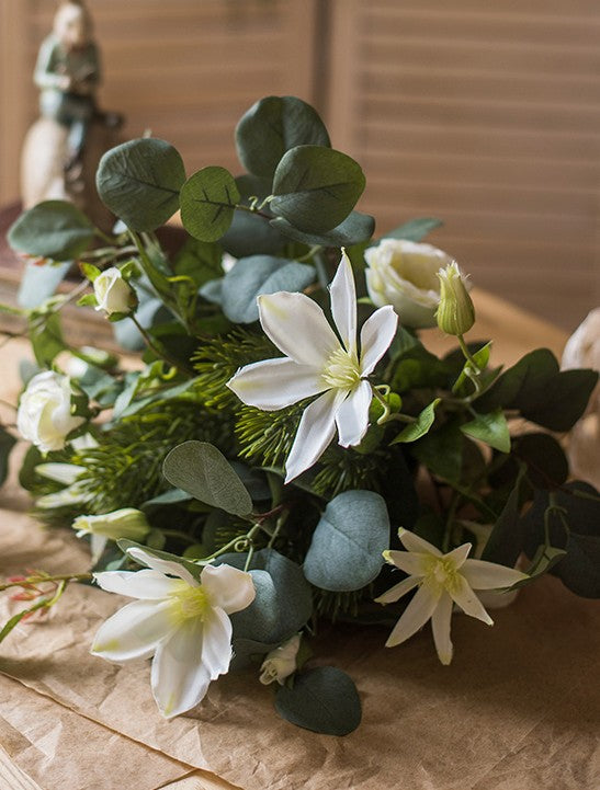 Eucalyptus globulus. Clematis. White Rose Flowers. Unique Flower Arrangement for Home Decoration. Beautiful Modern Artificial Flowers for Living Room