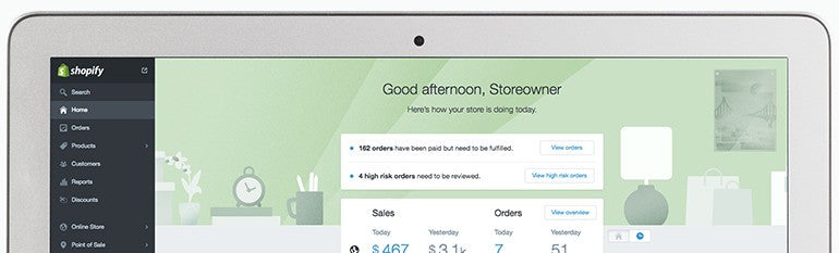 Storeowner's computer displaying Shopify Admin dashboard